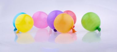 Beyaz bir arka plan üzerinde renkli küçük balonlar