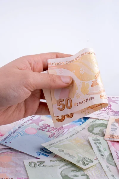 Hand hält türkische Lira-Banknote in der Hand Stockbild