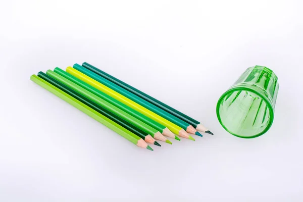 彩色铅笔和白色背景上的绿色玻璃 — 图库照片