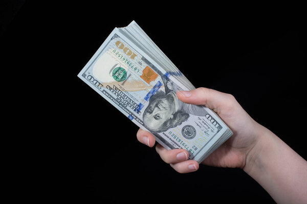 Hand holding American dollar  banknotes isolated on white background