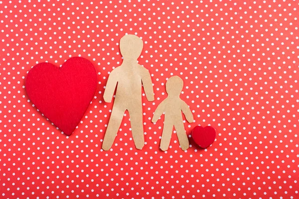 Heart and man and child shape cut out of paper