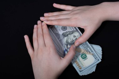 Beyaz arka planda el ele tutuşan Amerikan doları banknotları