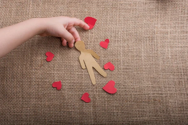Love concept for with paper hearts and paper man