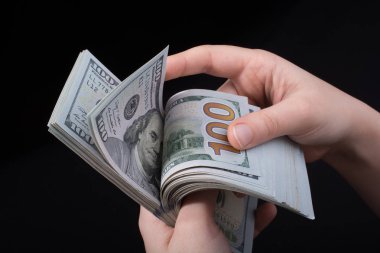 Beyaz arka planda el ele tutuşan Amerikan doları banknotları