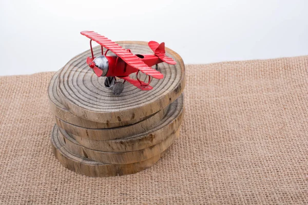 Red color toy plane on wooden texture — Stock Photo, Image