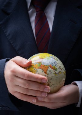 Man holding an earth globe model in his hands