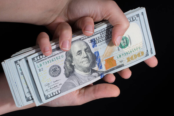 Hand holding American dollar  isolated on white background