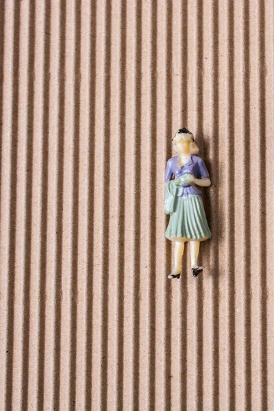 Little woman figurine on paper background