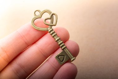 Kalp şeklinde eski sevgililer günü metal anahtarı elinde.