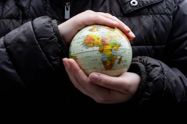 Man holding an earth globe model in his hands — 스톡 사진