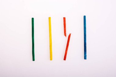 Colorful sticks with broken one in the middle