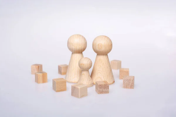 Woodencubes and  figurines of people as family concept — 图库照片