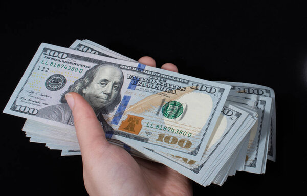 Hand holding American dollar  isolated on white background