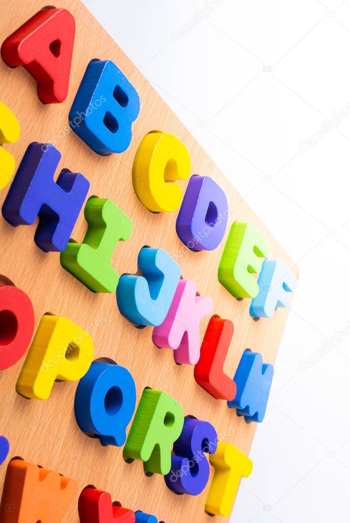 Colorful letter blocks on board on white
