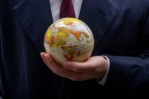 Man holding an earth globe model in his hands — Stock Photo, Image