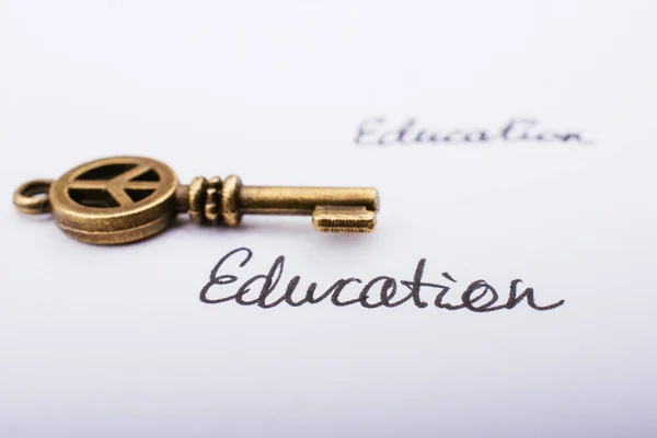 Education wording beside a retro style key on white background — Stock Photo, Image