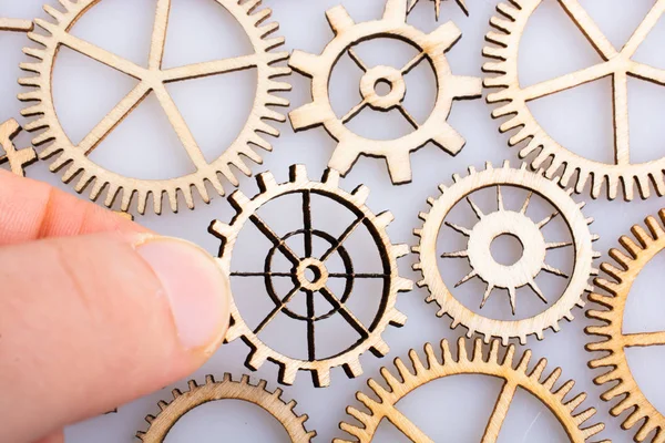 Gear wheel in hand on white background as concept of engineering — Stock Photo, Image