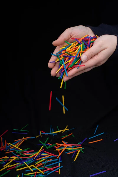 Hand Letting Coloured Wooden Sticks Fall Black Background — Stock Photo, Image