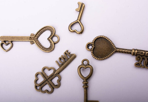 Heart shaped retro metal keys on white background