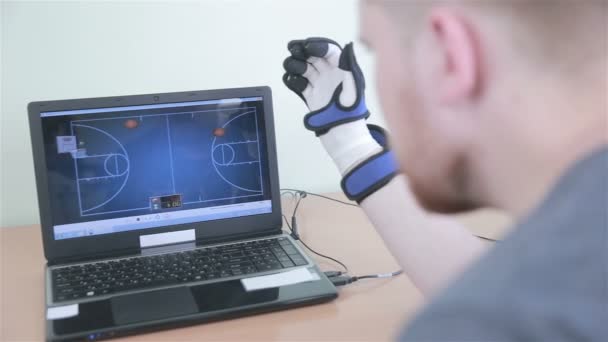 Electronic high-tech cyber glove. Man plays VR game operating with 3D bionic simulator glove. — Stock Video