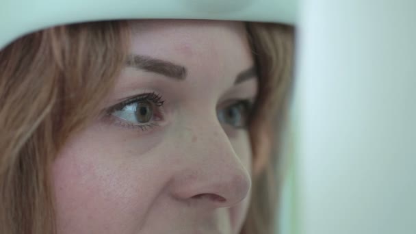 Young woman having her eyes examined by an eye doctor on a modern medical equipment. — Stock Video