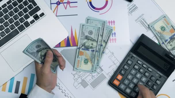 Businessman counting money. Accountant Workplace with laptop, graphs, calculator. Top view. — Stock Video