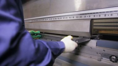 Bir fabrikada modern bir bükme endüstriyel makine üzerinde sac işçisi eller viraj.
