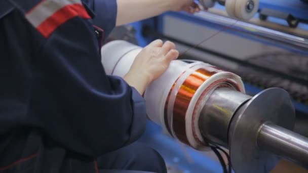 Transformer, engine production. Worker operates with electric cooper wires, winding of the transformer. Steadicam shoot. — Stockvideo