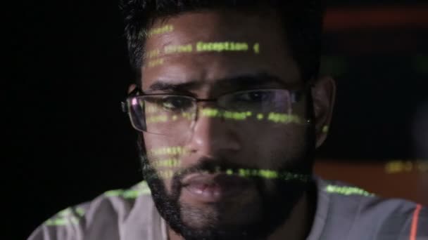 Data code reflection on programmers face. Hackers in glasses hacking programm code at night. — Stock Video