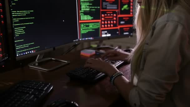 Manos femeninas tecleando código de computadora, hackeando computadoras en una habitación oscura. Hacker, programador en el trabajo . — Vídeo de stock