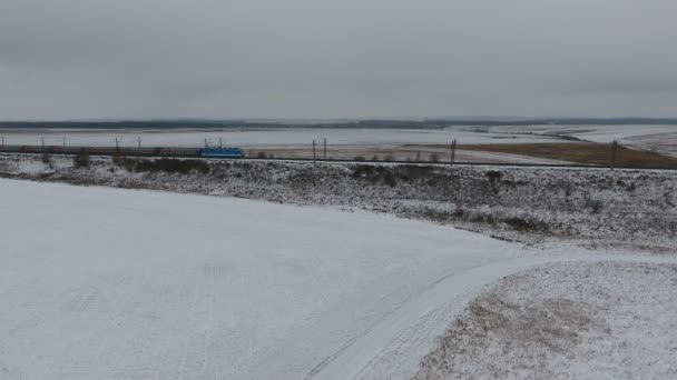 El tren se mueve a lo largo del ferrocarril. Tren de pasajeros y vagones. Invierno. Antena . — Vídeo de stock