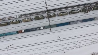 Uzun yük treni demiryolu istasyonunda kış geliyor. Hava ateş.