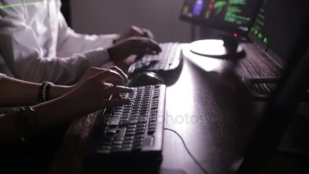 Hackers hands typing on keyboard in dark. Team of hackers. — Stock Video