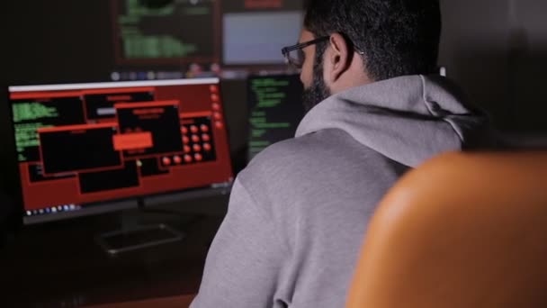 Programmer from behind. It professional programming code on computer monitor. — Stock Video