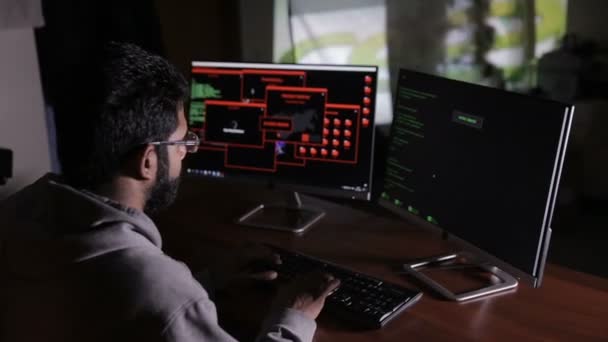 Programmer from behind. It professional programming code on computer monitor. — Stock Video