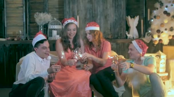 Group of friends celebrating Christmas, New Year. Having fun, playing with sparkles at Christmas party. — Stock Video