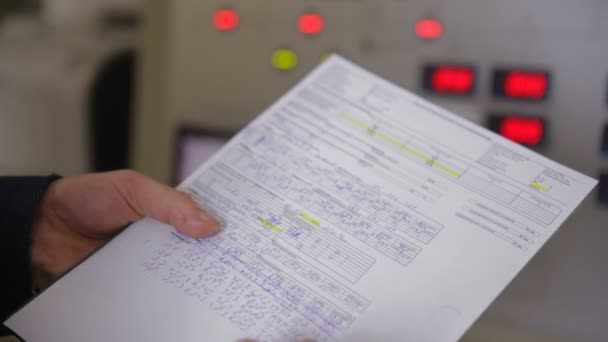 Engineer hands writing information from industrial electronic control board, control panel. — Stock Video