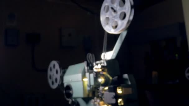 Film projector. Old movie projector working in dark. Dolly shot. — Stock Video