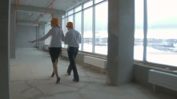 Architecte et investisseur, hommes d'affaires vérifiant les nouveaux bâtiments dans la construction intérieure. Mouvement fluide de la caméra, prise de vue steadycam . — Video