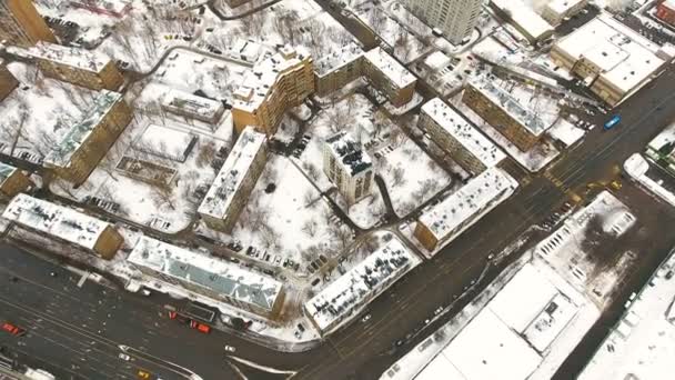 Street traffic and buildings in snow from above. Winter. Aerial. — Stock Video