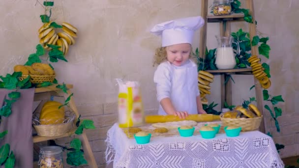 Lovely kid making dough in the kitchen decorations. — Stock Video