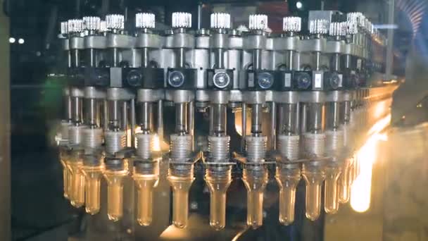 Plastic forms for PET bottles are heating in industrial PET blowing equipment. — Stock Video