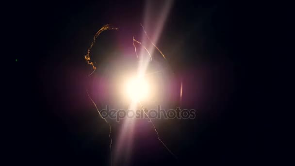 Female boxer training. Woman silhouette making shadowboxing. Strong light behind her. — Stock Video