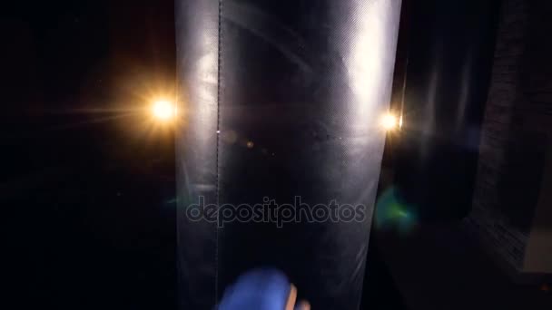 Hand of female boxer strikes punching bag. — Stock Video