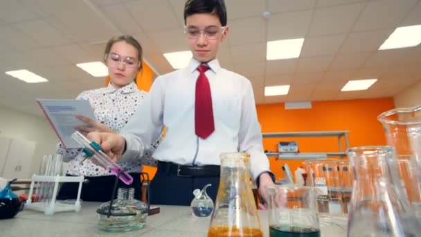 Μαθητές δευτεροβάθμιας εκπαίδευσης κάνοντας πειράματα επιστήμης. Έννοια της εκπαίδευσης. — Αρχείο Βίντεο