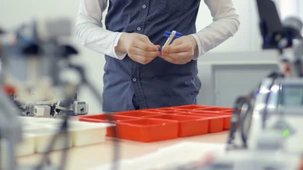 Young boy hands playing a construction toy. — Stock Video