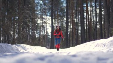 Güzel genç kadın güzel kış ormandaki bir sırt çantası ile hiking.