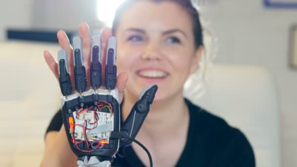 Happy disabled lady touching the robot hand with her healthy palm. Close-up. — Stock Video