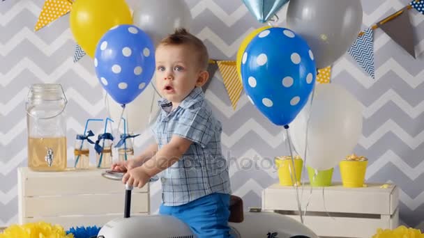 El chico está conduciendo un coche, lo presentó para su cumpleaños . — Vídeos de Stock