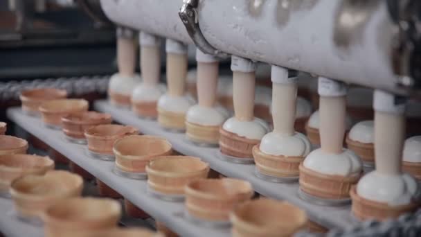 The ice-cream cones moving on the conveyor to be filled in. HD. — Stock Video